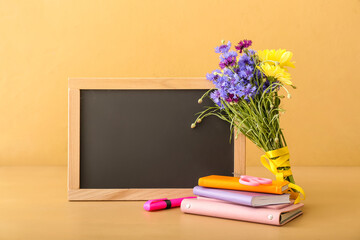 Flowers, stationery and blackboard on color background. Teacher's Day celebration