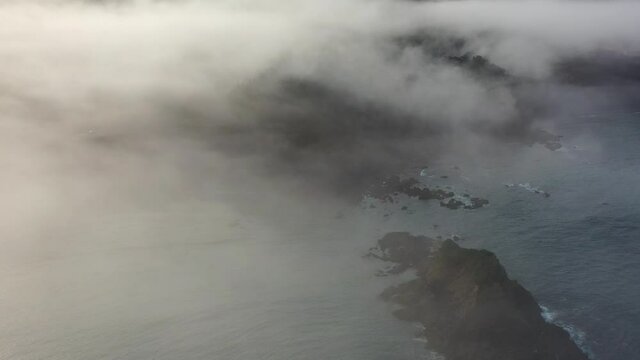 Fog drifts over the rugged, rocky coast of Mendocino, California. The foggy marine layer is generated by a pressure gradient as a result of warmer inland temperatures. 