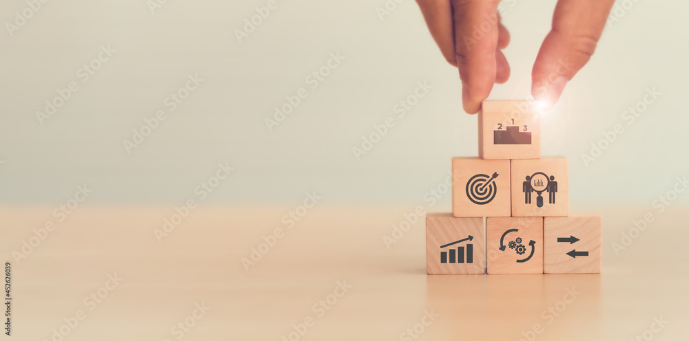 Wall mural benchmarking concept. comparing business processes and performance. man hold wooden cubes performanc