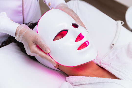 Photodynamic therapy facial mask on woman's face