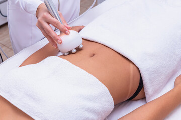 Cropped shot of a professional dermatologist performing radiofrequency lifting procedure on the...