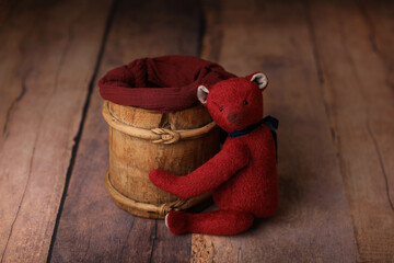 Newborn photography digital background prop.	
Vintage bucket with red teddy bear on a wooden...