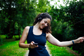 Happy girl in listen music in headphones