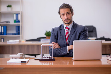 Young man businessman employee sitting in the office