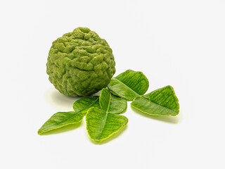 Fresh bergamot fruit and green leaves isolated on white background with clipping path. Close-up photo. Healthy foods concept