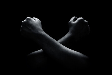 Fototapeta premium Hands crossed isolated on black background