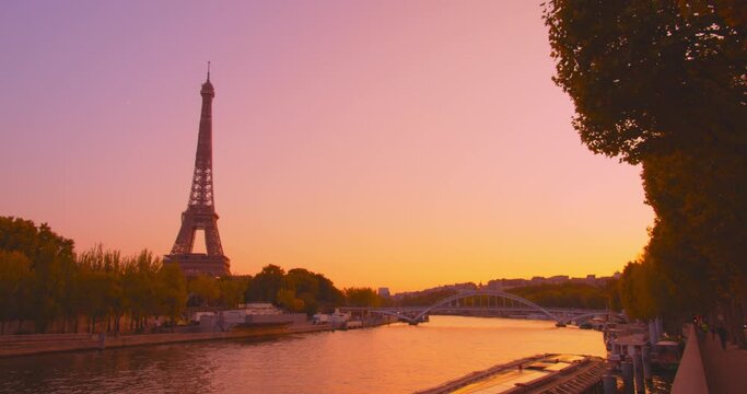 Beautiful Eiffel Tower during golden yellow sunset near river Seine, static view