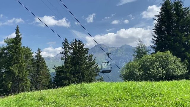 A chairlift in summer in the vacation region Lenzerheide - Arosa in the canton of Grisons Switzerland. It's summer and the chairlift goes for the hikers