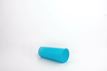 Spilled blue plastic cup isolated on white background