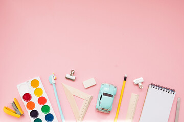 Yellow school supplies on pastel pink background. Back to school. Flat lay
