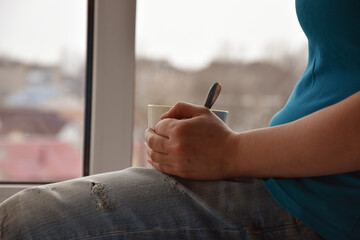 Faceless woman drinking rea