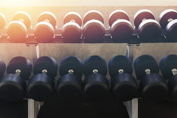 Rows of dumbbells in sport gym. Fitness equipment in the gym.