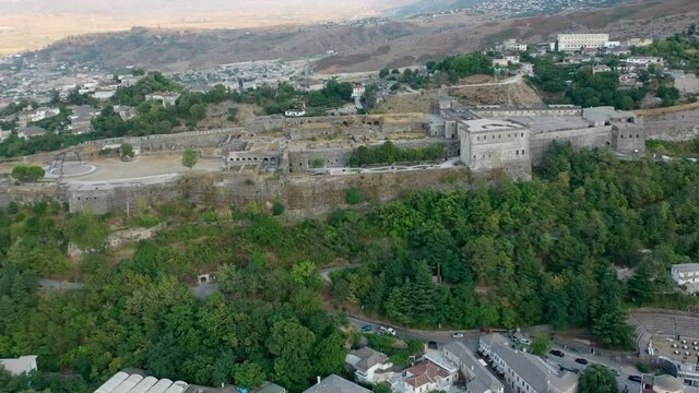 Castle of Gjirokastra and city center. Aerial view of ancient fortress Albania