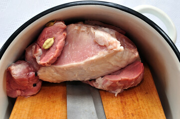 Fresh raw meat on the pan with knife and wooden board, close up