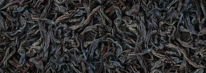 dried tea leaves close up. Black tea loose marco background