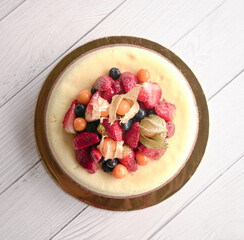 Vanilla and coffee cheese cake with fruits topping. Top view.