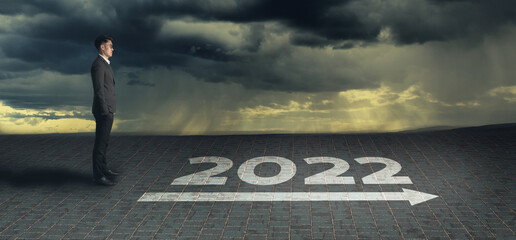 New year 2022; business plan concept. Businessman look forward to the opportunity in 2022 on the road  background. Used for business plan and strategy to achieve goals and success. Banner, Copy space.