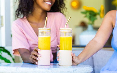 Glasses for smoothies in the hands of girls.