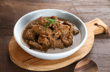 Daging Kelem is a traditional food from Central Java, Indonesia, made from beef, coconut milk and spices. It tastes sweet and savory. Served in bowl, close up.
