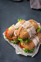 Fresh rye bread sandwich with ham, lettuce and tomato