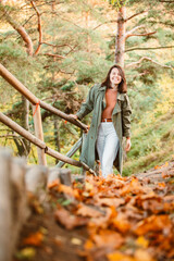 young adult smiling woman walking outdoors enjoying autumn weather