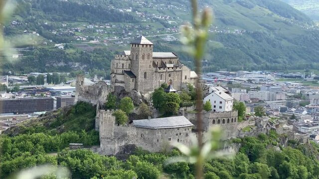 The Valeria Castle next to the Tourbillon Castle in Sion, Canton Valais in Switzerland. The castle stands on a hill and the city of Sion can be seen in the background.