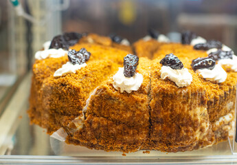 Cakes in the supermarket. Sweets under glass. Sweets buffet