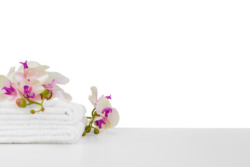 Fototapeta premium Spa composition with towels and flowers isolated on white