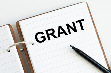 white background on which lies diary with word Grant