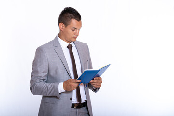 a young handsome businessman in a suit with a notebook