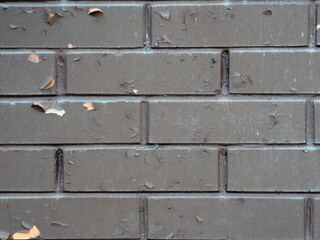 Weathered texture of painted old dark brown and red brick wall background. Brickwork.