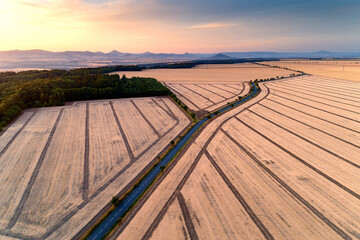 Sunset over fields with stripes