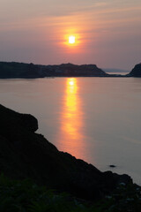 golden sunset with silhouette coastline