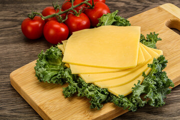 Sliced Gauda cheese over board