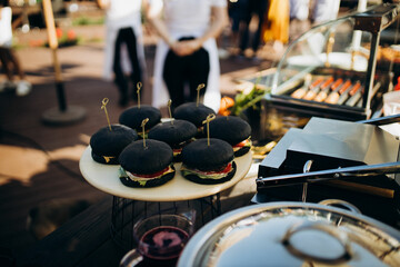 cooking black burgers outdoors