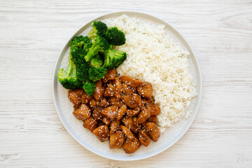 Homemade Teriyaki Chicken with Rice and Broccoli on a plate on a white wooden surface, top view. Flat lay, overhead, from above.