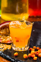 Sallow-thorn liqueur wit sallow-thorn berries on bar background