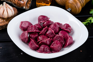 Tasty beetroot ravioli, Beetroot ravioli stuffed with baked beets and meat. Vegetarian food. Colored dumplings in a white plate