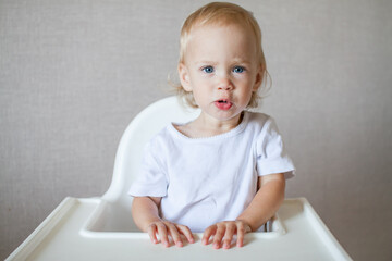 Portrait of a little cute child in a white t-shirt. High quality photo