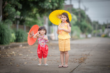 close-up background view of an asian girl Running around and carrying parasols during school holidays, there was a blur of fun movements during the day with parents.