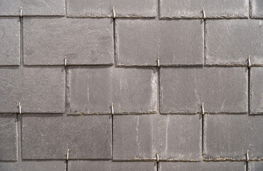 Close up of an old tiled wall in Honfleur, France, for an abstract background texture.