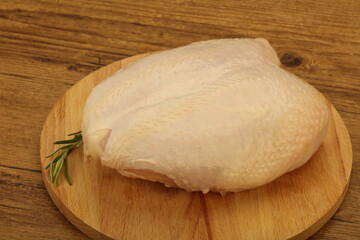 Raw whole chicken breast with skin