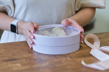 woman entrepreneur packs the order in a beautiful box, perfect service for customers.