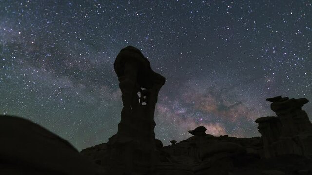 Time lapse tracking shot of Milky Way galaxy over Alien Thorne at Valley of Dreams in Bisti Wilderness in New Mexico