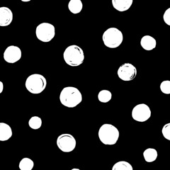 Polka dot seamless pattern. White dots on black background. Trendy texture for print, textile, packaging. Hand drawn vector illustration.