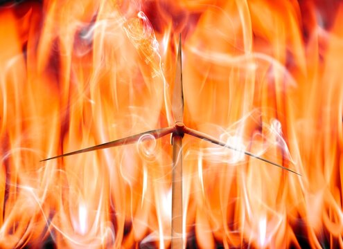 Wind turbine and flames, conceptual illustration
