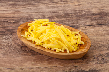 Shredded yellow cheese in the bowl