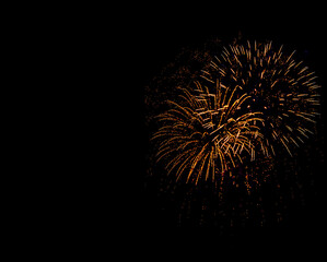 Holiday Fireworks at New Year Eve. Abstract Festive background with fireworks sparkles. Copyspace.