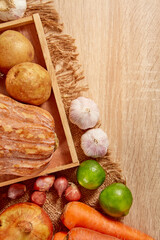 Prepare ingredients for healthy and nutritious meals. Potato, carrot, dry onion, red pumpkin, lemon on brighten wooden background. Top view. Clean and Fresh Food. Healthy vegetables. Space for text