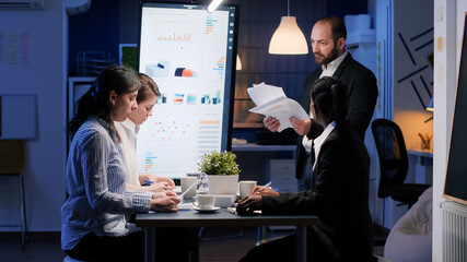 Furious nervously businessman screaming while working in office meeting room late at night. Exhausted disappointed entrepreneur man throwing company statistics paperwork leaving business office